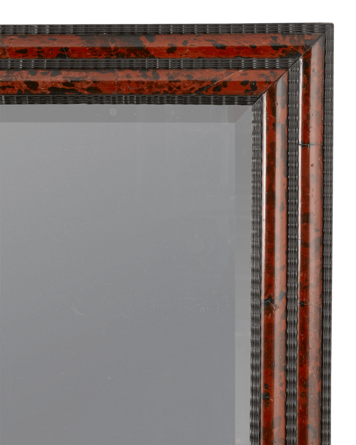 The beveled edges of this mirror enhance the sense of depth created by the luxurious frame