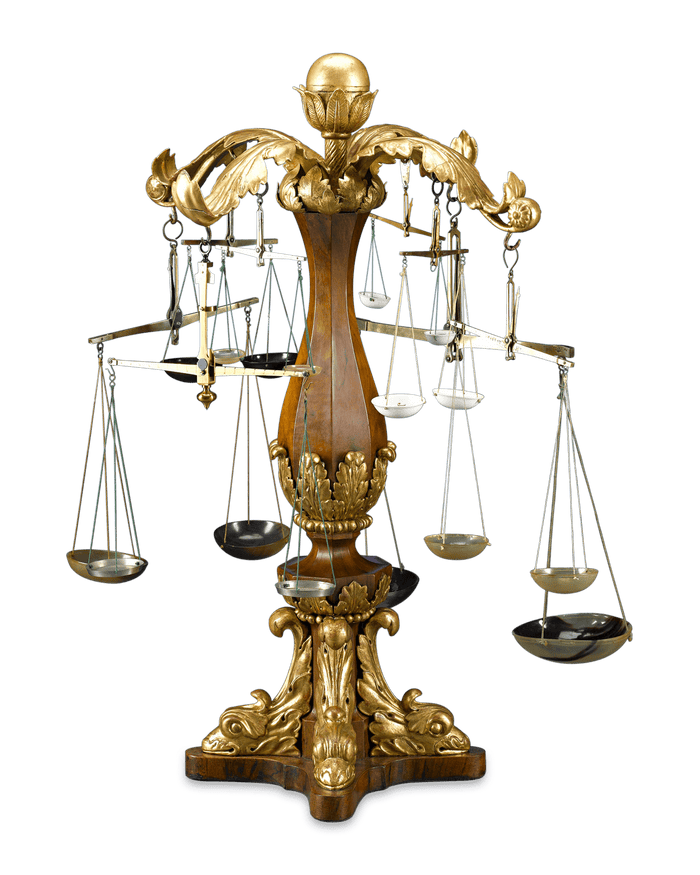 A collection of eight antique balances hang from its arms
